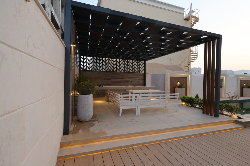 A slatted aluminium pergola over a dining terrace with concealed lighting, project A20 in Ajman