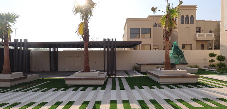 Maintained lawn, clipped hedging and mature palms in front of a villa, project A33